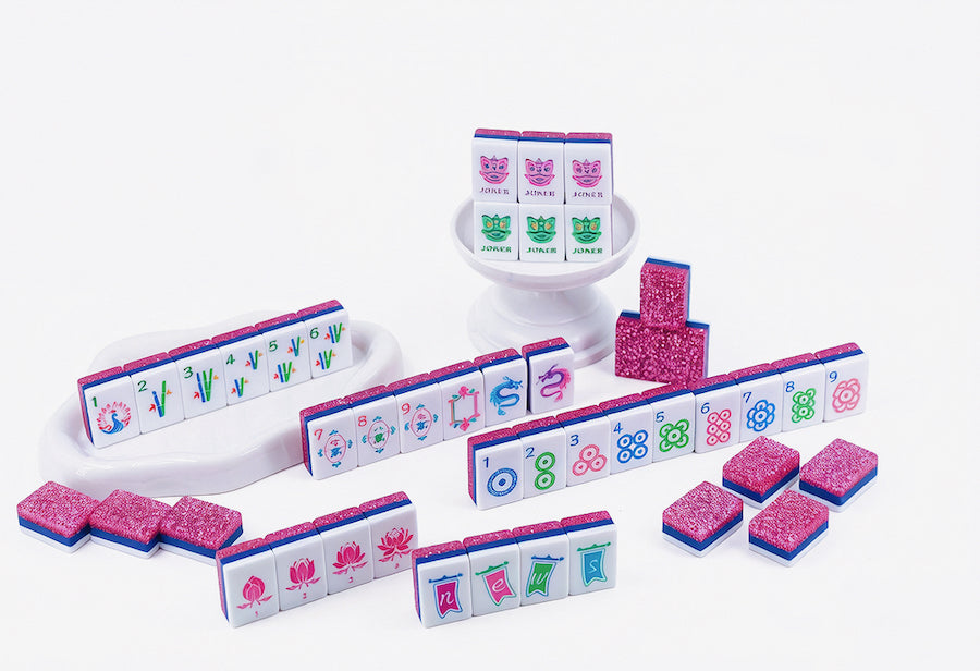 Mahjong tile set with suited tiles, white racks, and pink stardust blocks