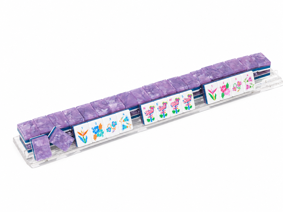 Mahjong tile rack with lavender-tinted tile ends and colorful face cards
