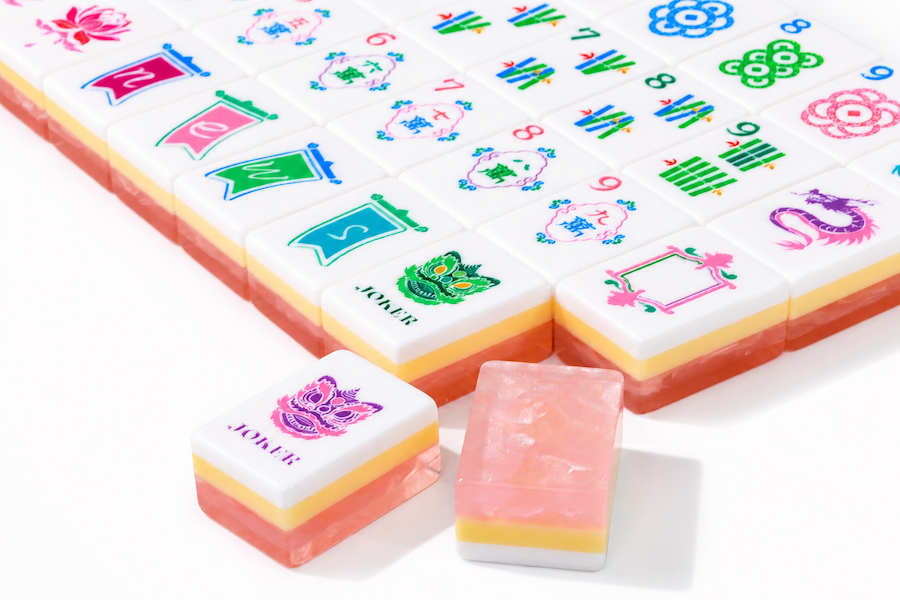 Mahjong tile set corner close-up with colorful suit tiles and peach-pink sides