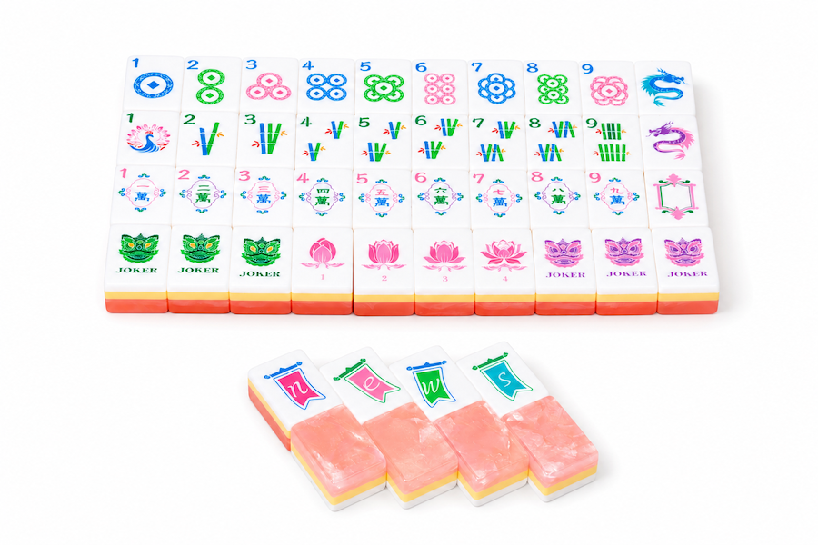Mahjong tile set with colorful tile faces and five peach-pink loose tiles
