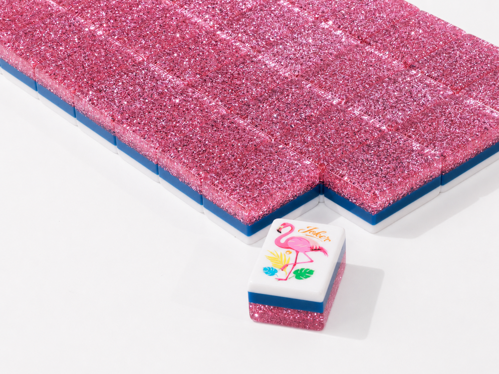 Stacked pink stardust mahjong tile with blue border and illustrated pink panel face