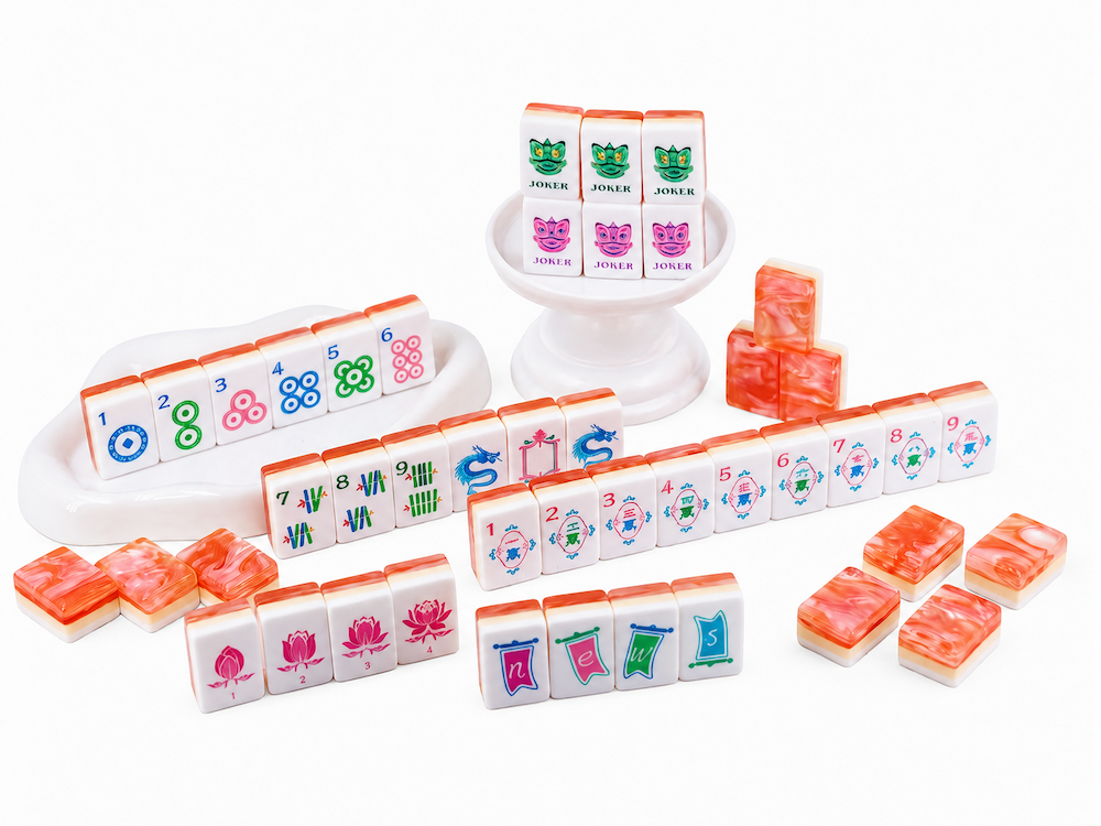 Coral Blush mahjong tile set with scattered tiles, white faces, and colorful symbols