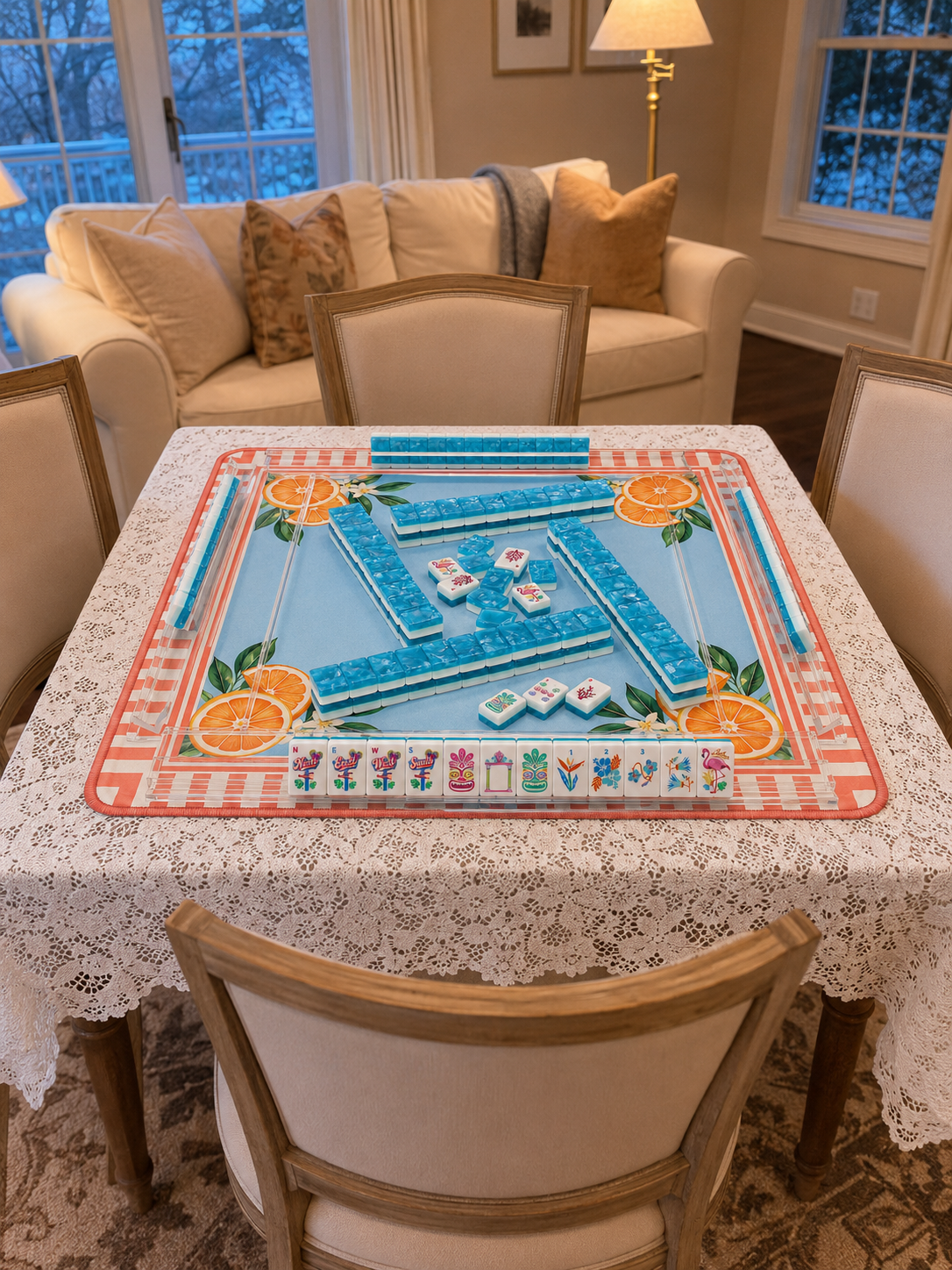 Mahjong tile set on a patterned play mat atop a dining table