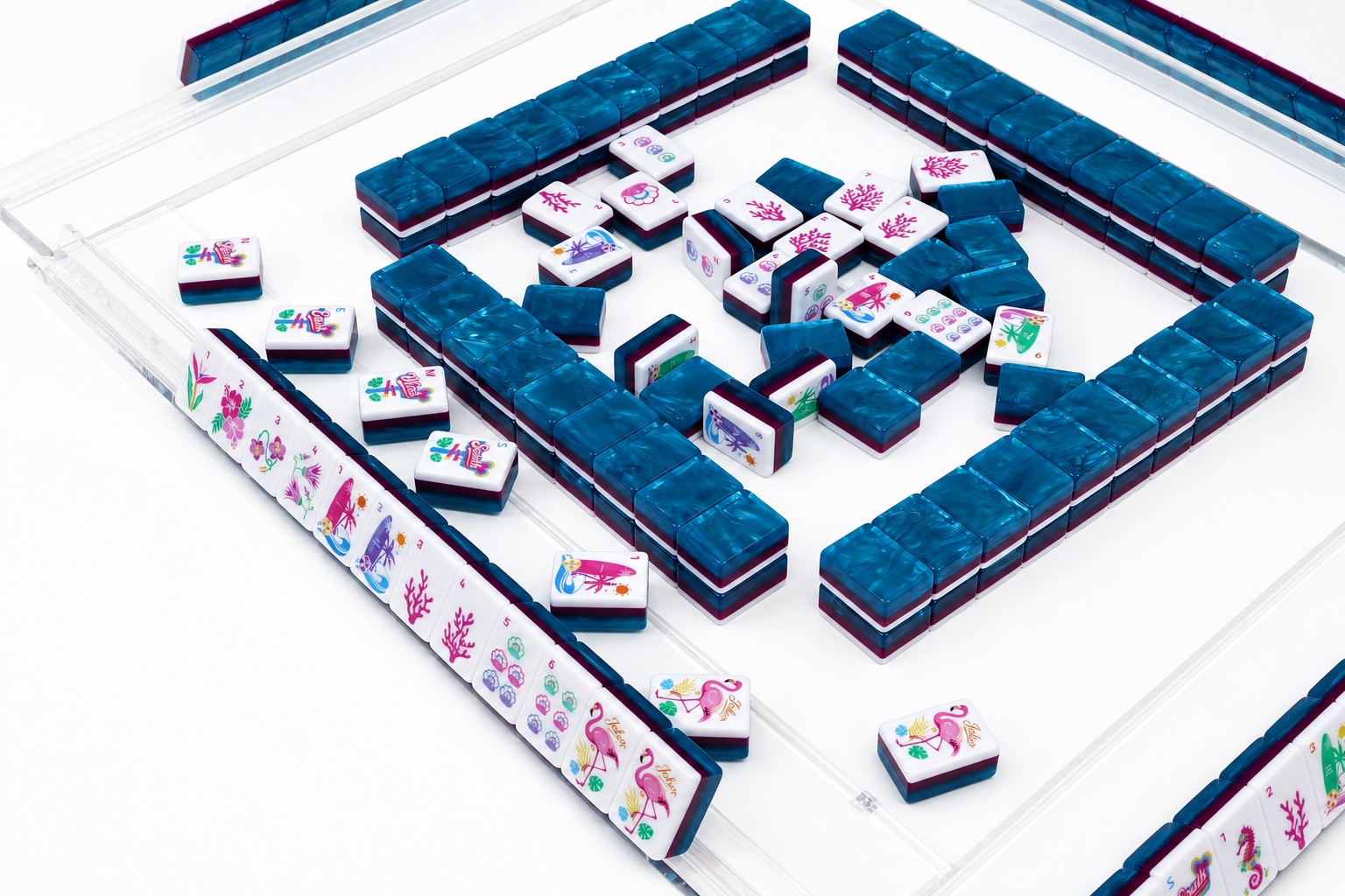 Mahjong tile table with blue tile racks and scattered floral tiles in center