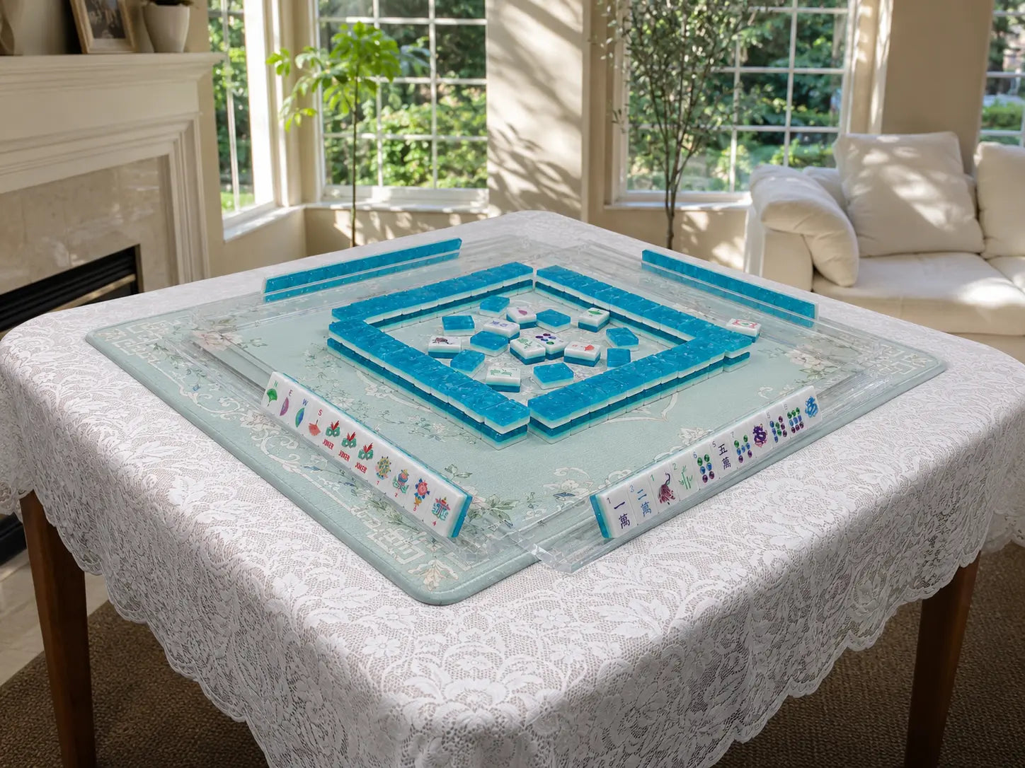 Complete American Mahjong setup with tiles, four compatible racks and a mat arranged on a square table
