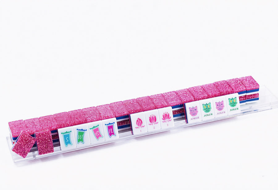 Mahjong tile tray with suited faces and pink stardust accent blocks