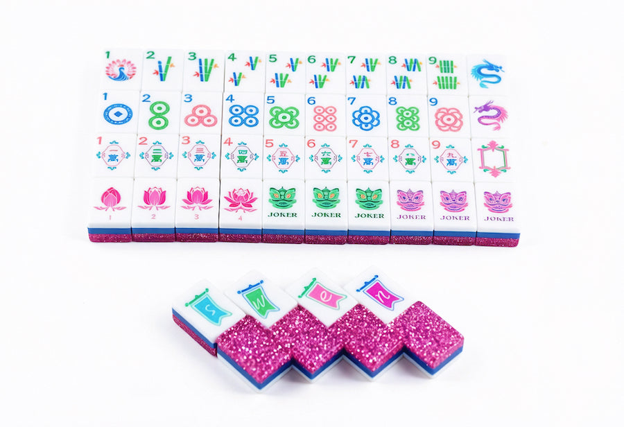 Pink glitter mahjong tile set with colorful suits on white tiles