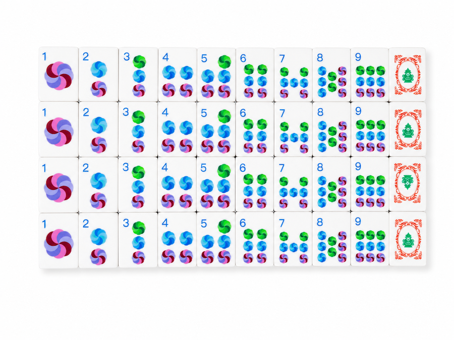 Mahjong tile row with colorful suits on white tiles, including red joker tiles