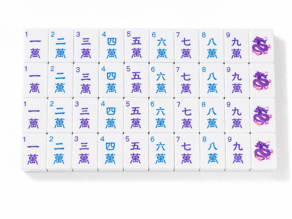 Azure Tide mahjong tile set close-up with purple characters and joker tiles at the ends.