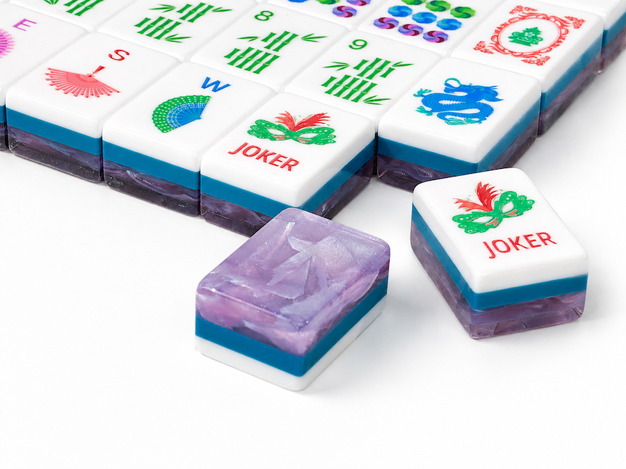 Mahjong tiles featuring red JOKER labels and purple stone-like insets with blue bases