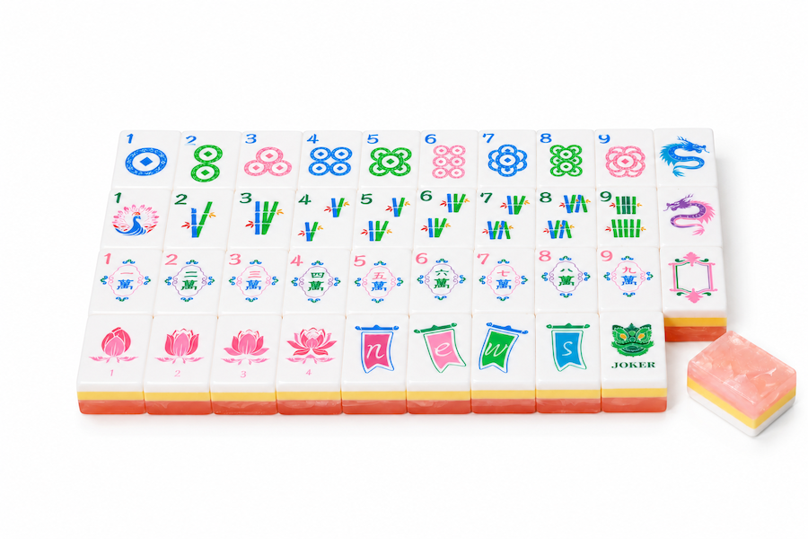 Mahjong tile set with full row of colorful tiles and a loose peach-pink tile