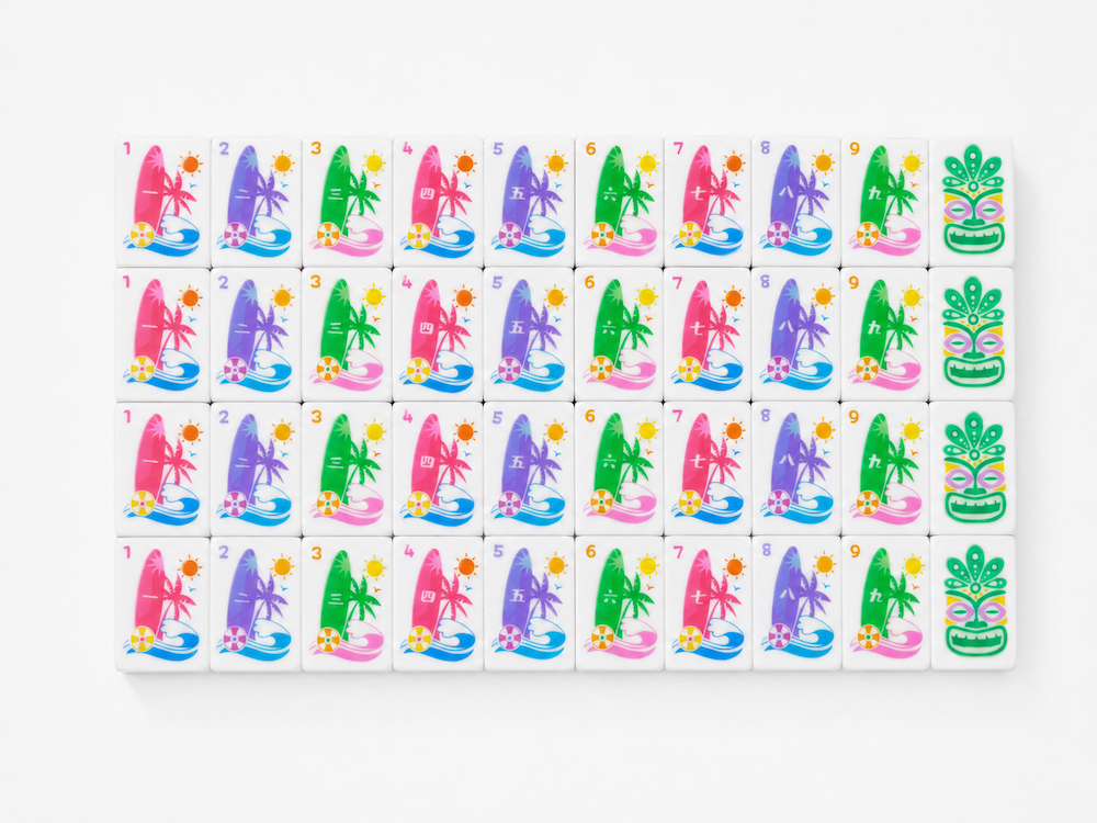 Mahjong tile set board with colorful illustrated character tiles and pink stardust accents