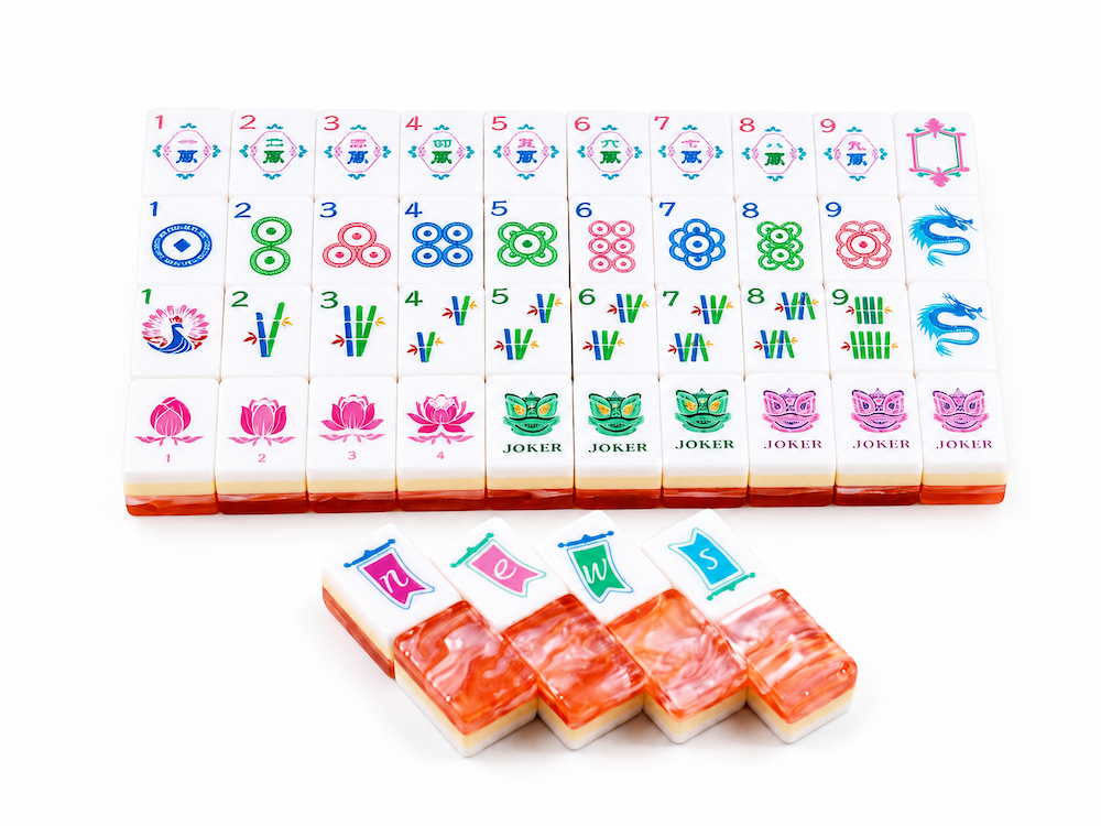 Coral Blush mahjong tiles arranged on a white base, featuring numbers, flowers, and joker tiles