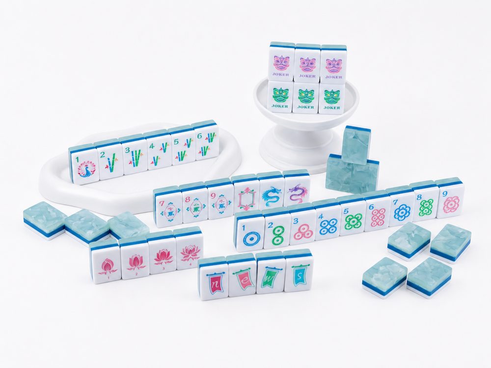 Mahjong tile set with white tiles, light blue edge tiles, and joker tiles arranged around