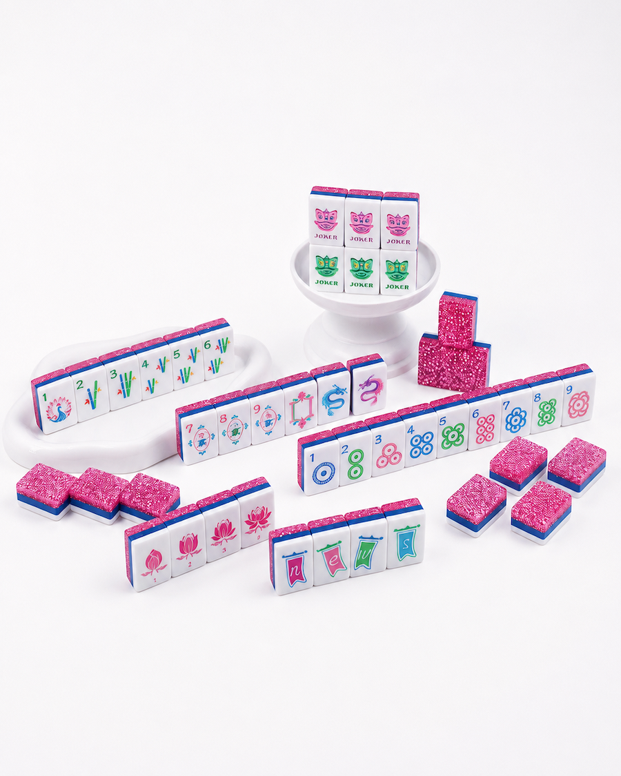 Mahjong tile set with white racks, colorful tiles, and pink stardust pieces
