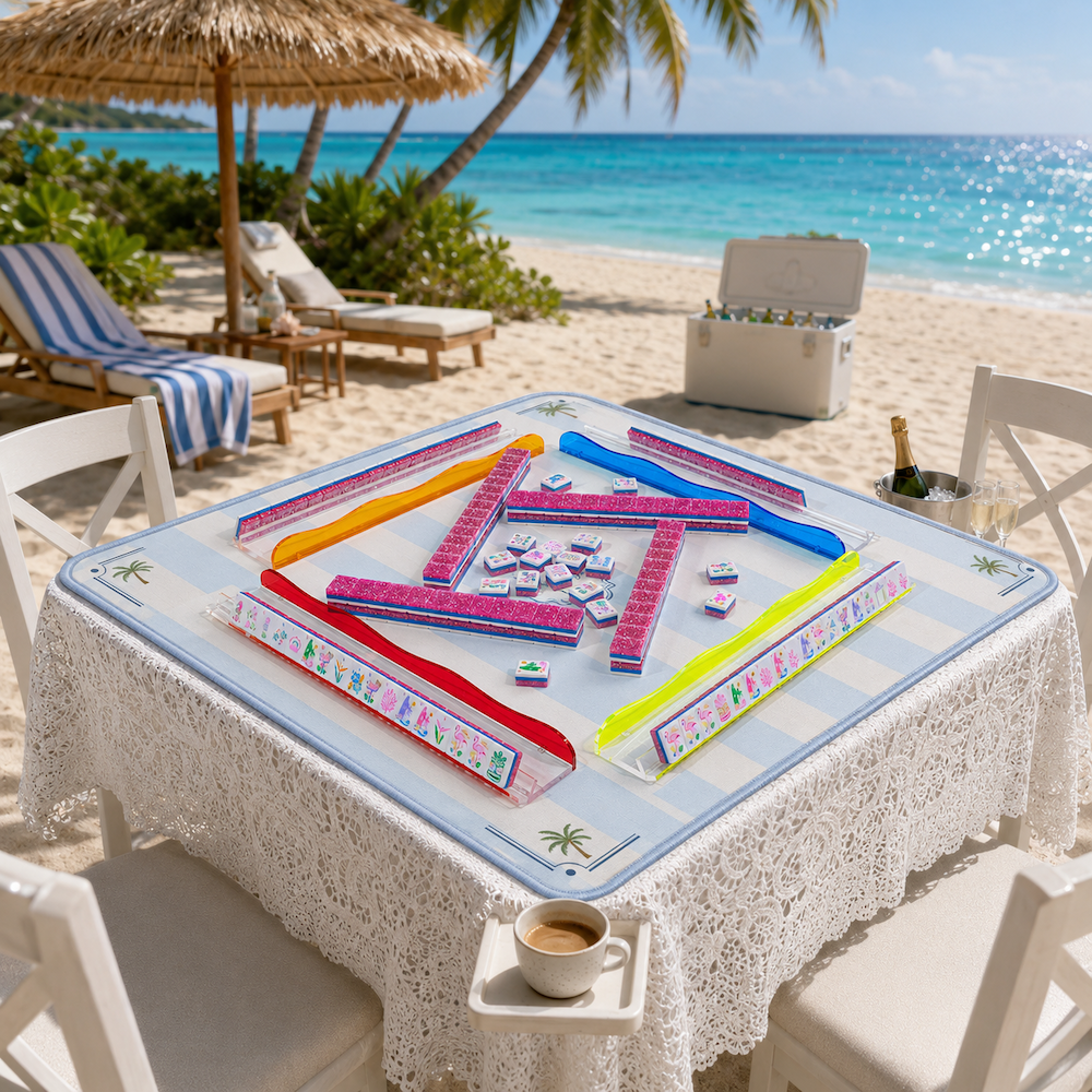 Pink and blue mahjong tile set in a rectangular play tray with tile racks