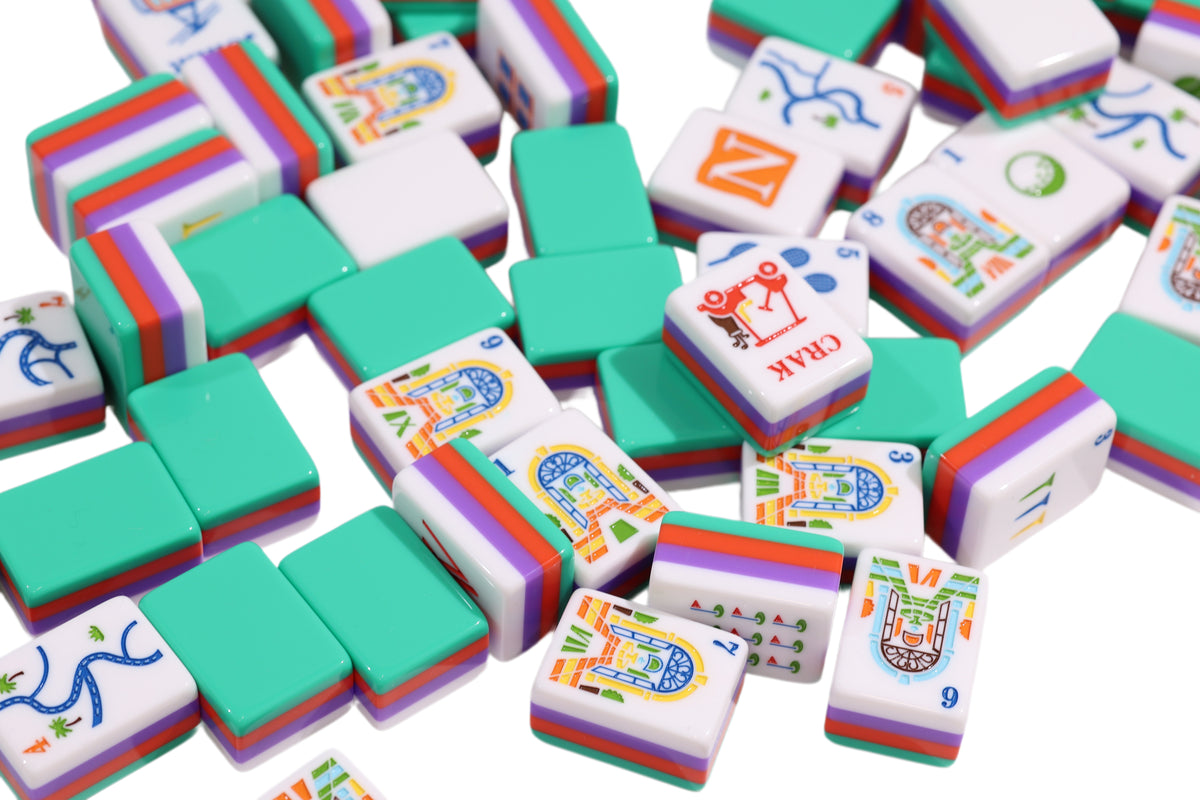 Resort Riviera Green tiles scattered to show green backs, colorful faces and layered edges #Colorway_Riviera Green