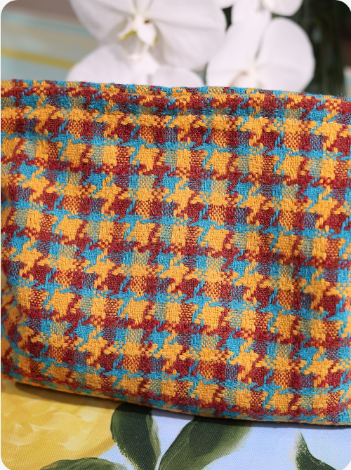 Multicolor woven stripe pouch with dense textured surface and rounded top