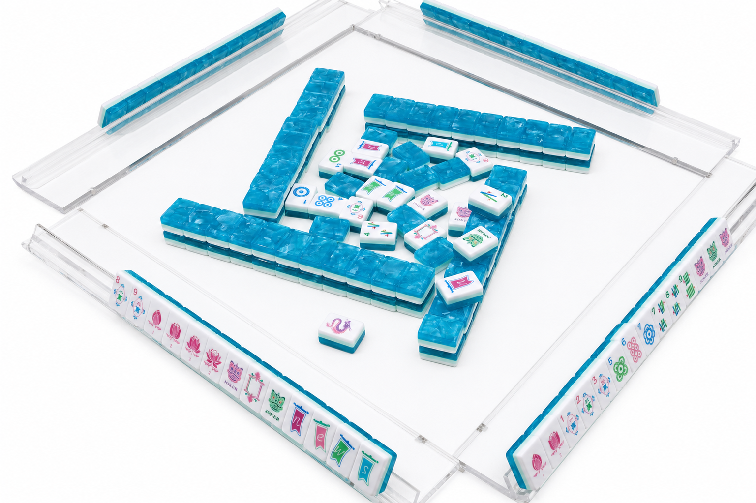 Mahjong table game with blue tile racks and a clear tray holding scattered tiles