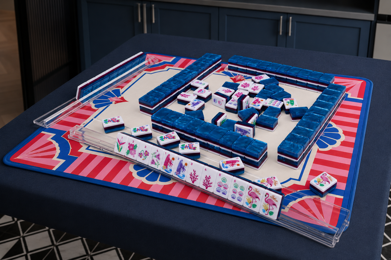 Mahjong tile table set with blue racks on a red patterned playing mat