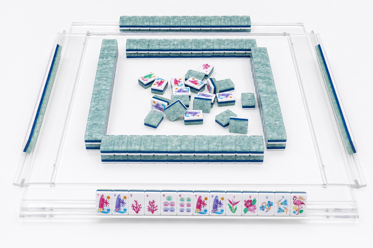 Mahjong tiles arranged inside a clear plastic case with a tile rack row
